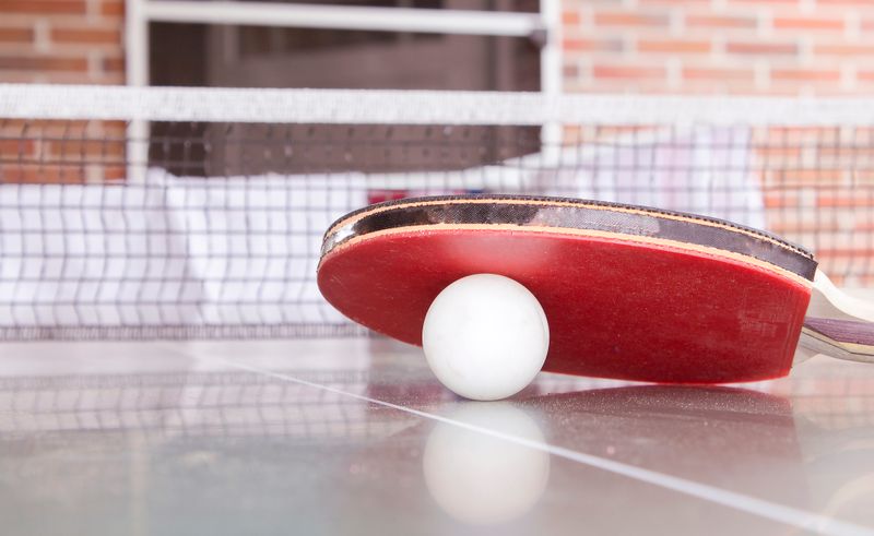 Close-up of a table tennis paddle and ball