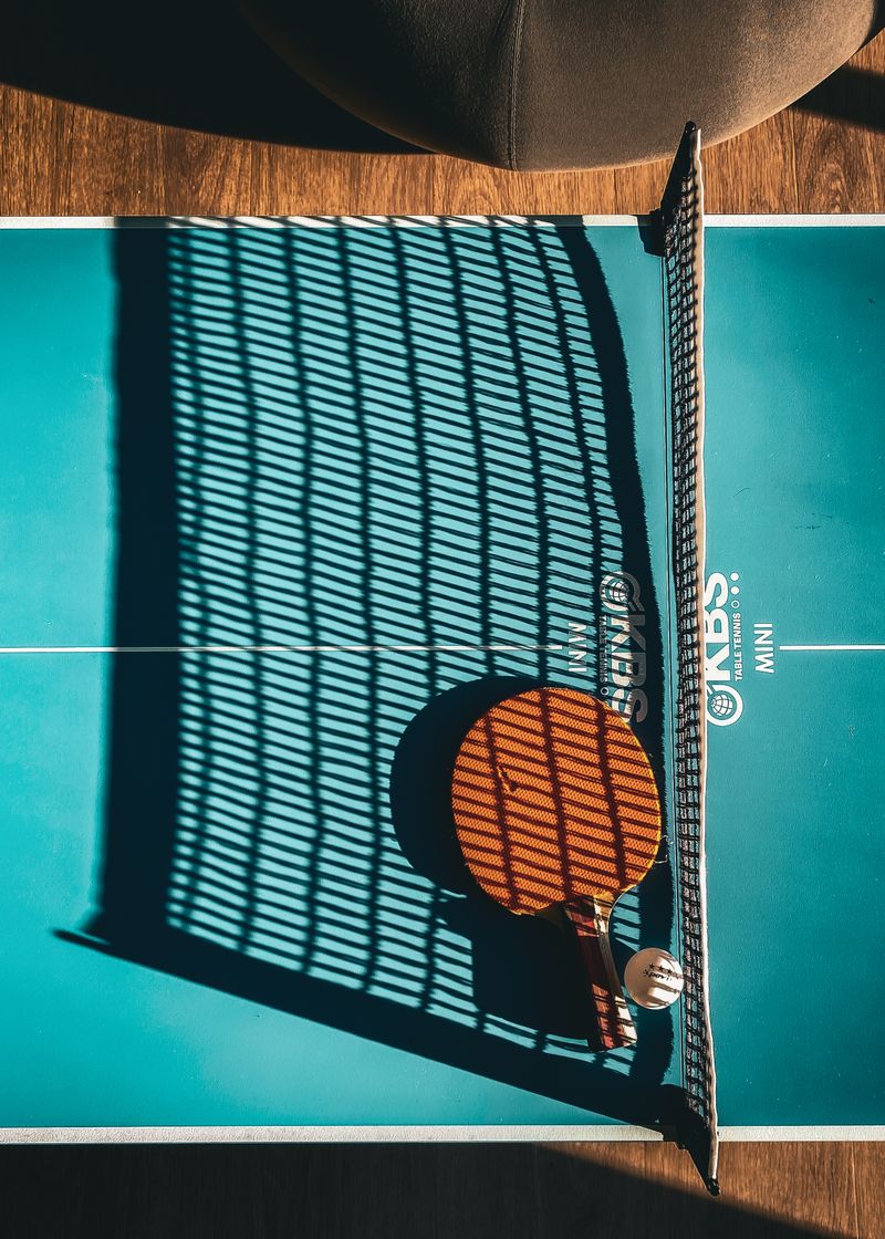 Table tennis paddle and ball resting on the table