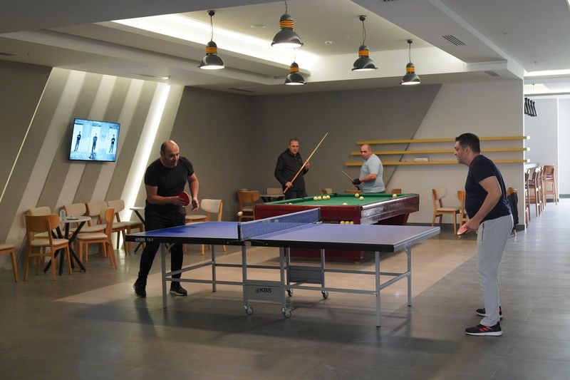 Group of players enjoying table tennis together