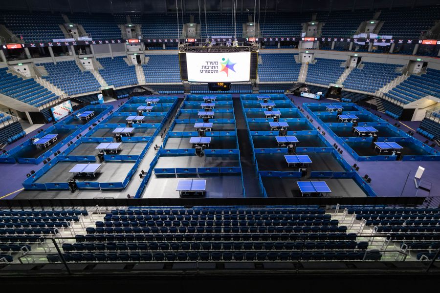 Aerial view of an indoor arena set up for a table tennis tournament